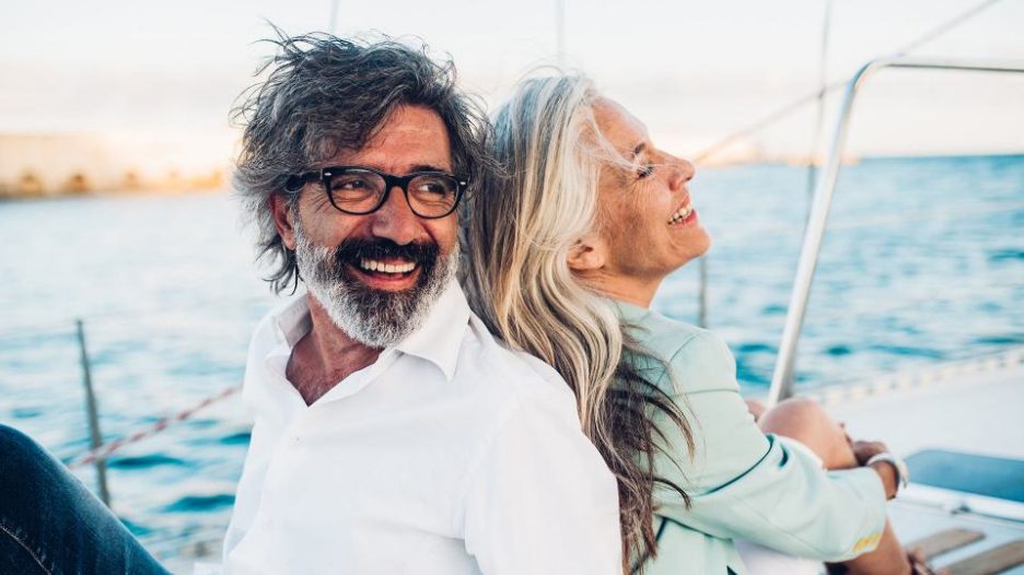 Mature carefree couple relaxing on a yacht on a sunny afternoon