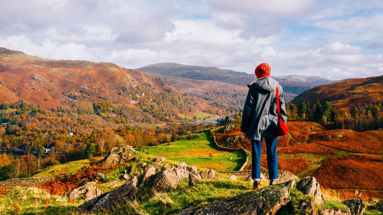 girl with a red hat on a hilltop