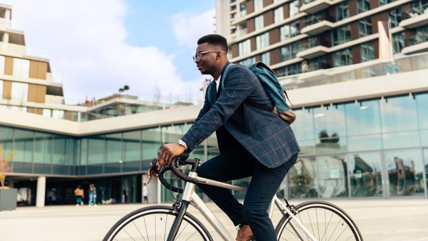 businessman commuting on bicycle in city