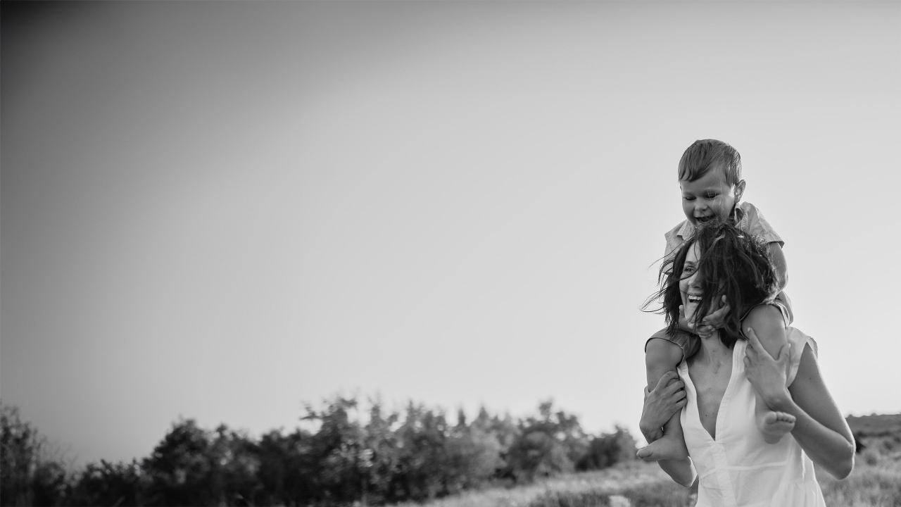 young boy on mums shoulders