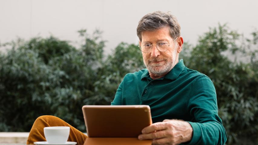 senior man using tablet