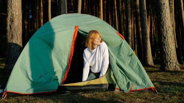 woman climbing out of a tent