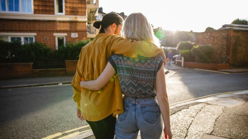 young couple walking along street