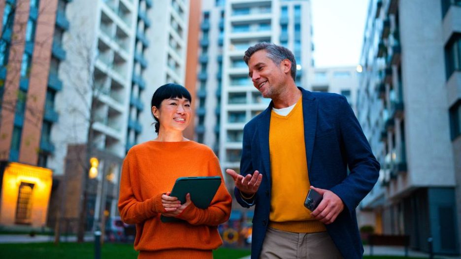 Business woman and man walking outside